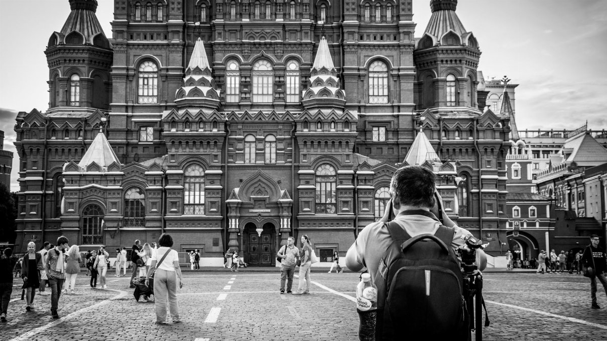Tourists captured in front of historic building in Moscow's Red Square.