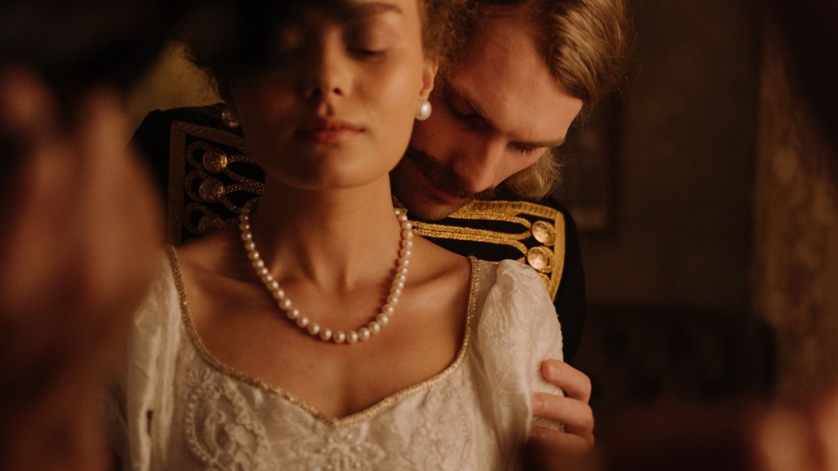 Intimate moment with a couple in period costume, exuding romance and elegance.