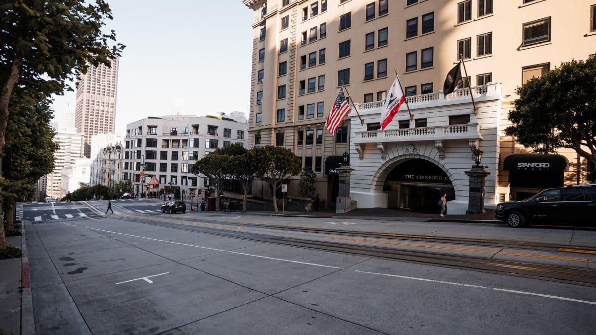 Streetscape of San Francisco featuring the Stanford Court Hotel and city architecture.