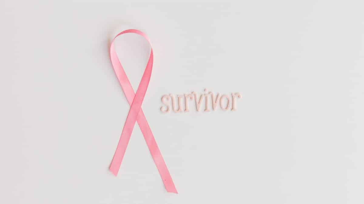 Image of a pink ribbon with 'survivor' text symbolizing breast cancer awareness.