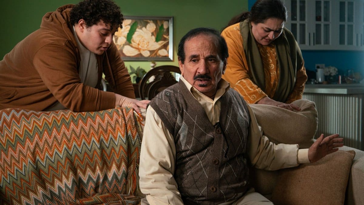 Family discussing and supporting each other in a cozy living room environment.