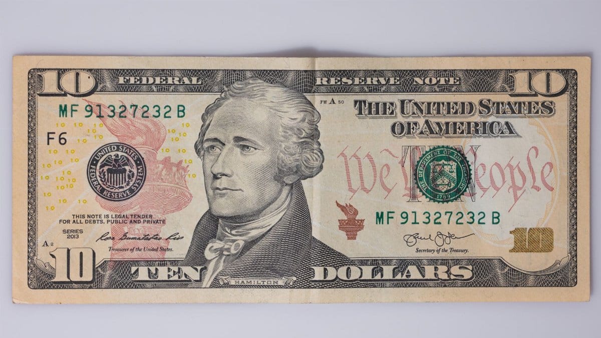 Detailed view of a US ten-dollar bill featuring Alexander Hamilton.