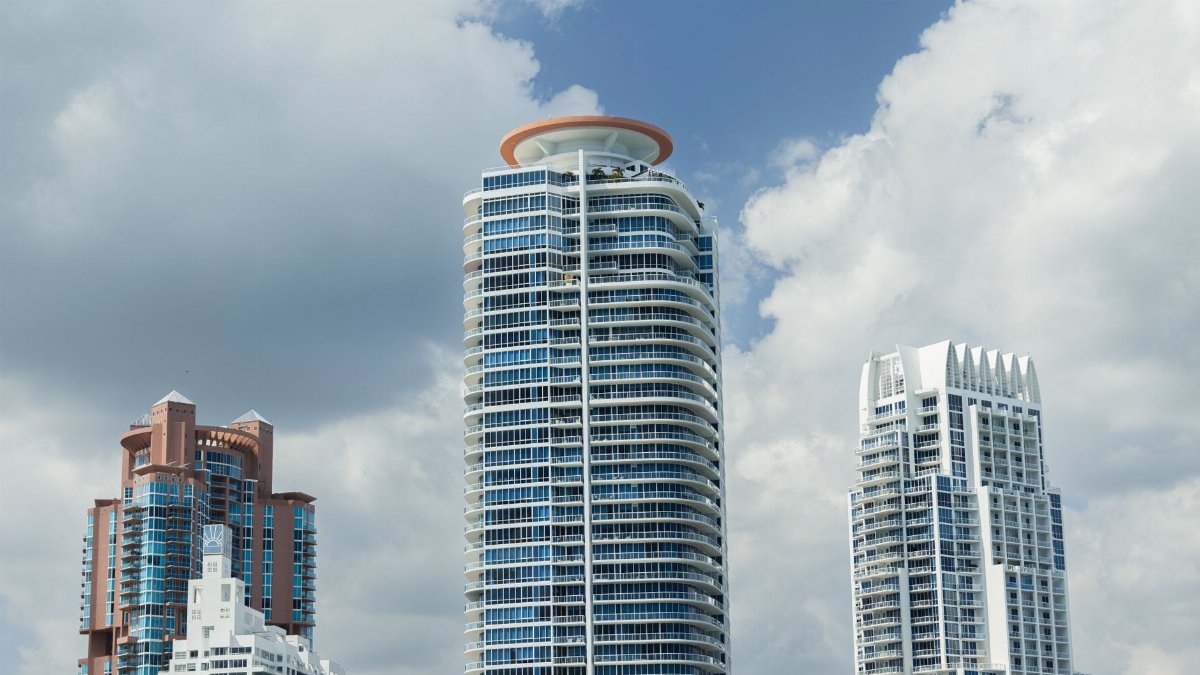 Captivating view of Miami's iconic modern skyscrapers under a bright, cloudy sky.