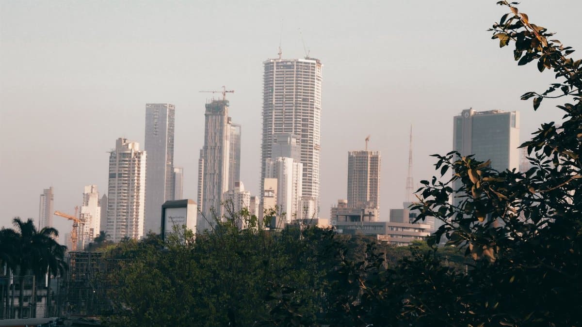 City skyline with skyscrapers and trees during the day, showcasing urban architecture.