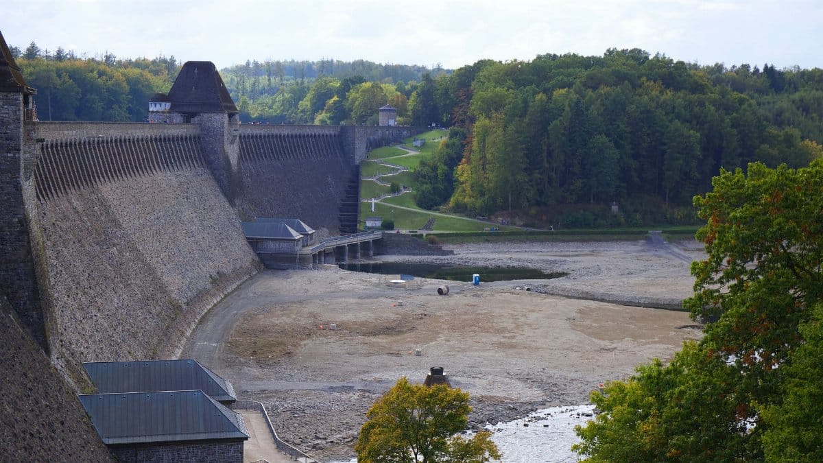 Aerial view of Edersee Dam surrounded by lush woodland and serene landscape in Germany.