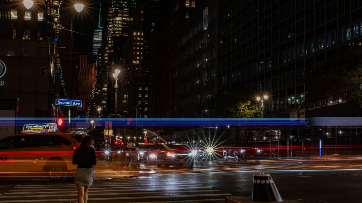 Vibrant city night scene with light trails on Second Ave, NYC showing dynamic urban life.