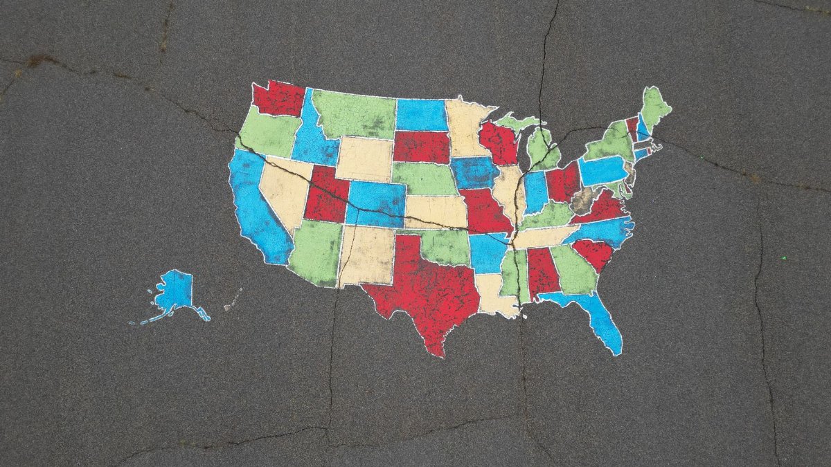 Vibrant map of the USA painted on pavement, showcasing bold state colors.