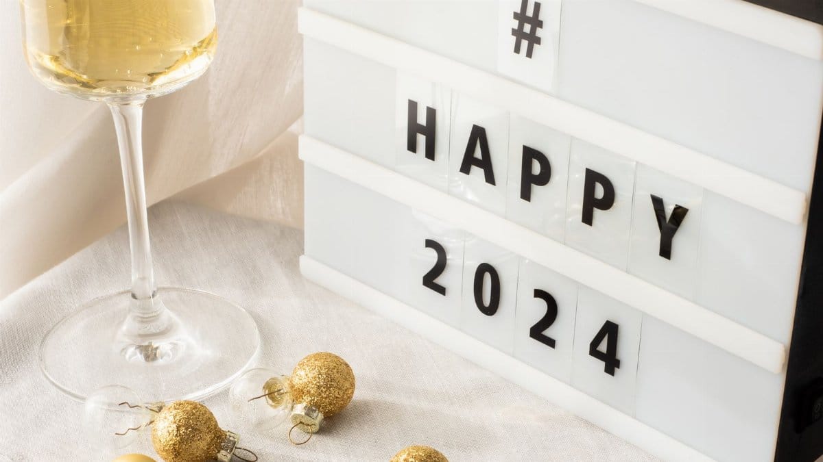 Elegant setting with champagne and decor for a festive 2024 New Year celebration.