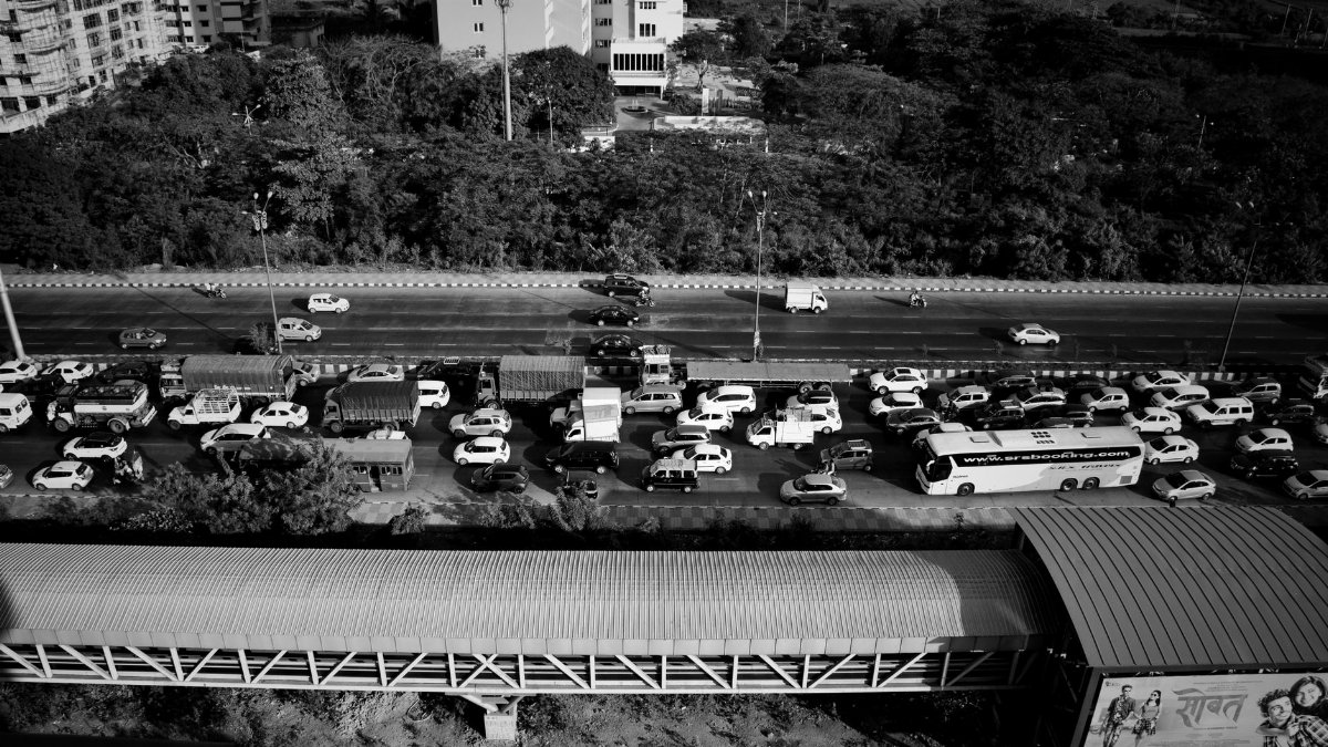 Black and white aerial view of a busy traffic jam on a Mumbai expressway.