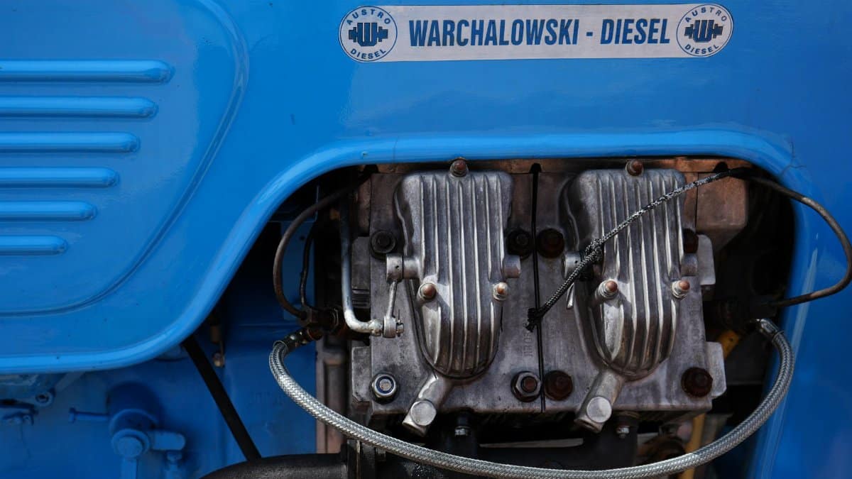 Detailed view of a Warchalowski diesel engine with visible components and vibrant blue cover.