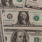 Close-up image showing a mix of U.S. dollar bills including $1, $5, and $10 bills.