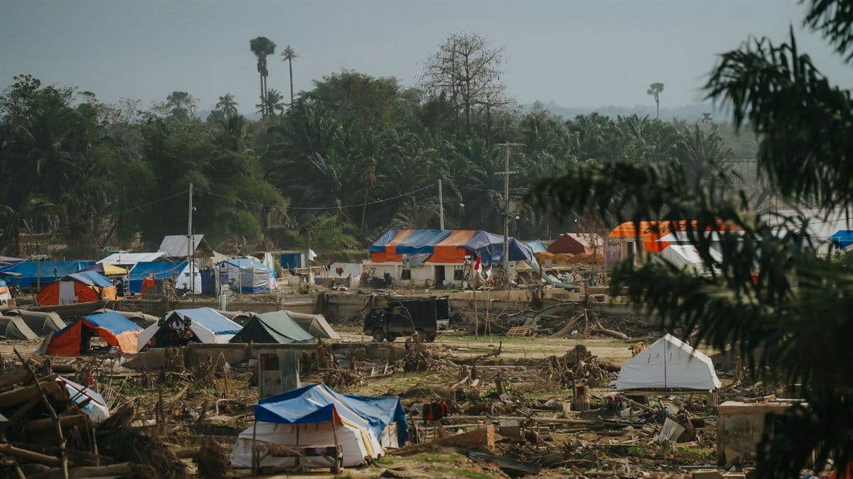Temporary shelters in a disaster relief camp nestled in lush greenery in Aceh, Indonesia.