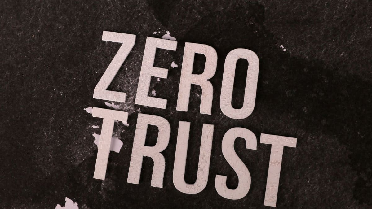 Bold 'Zero Trust' text against a textured black background, symbolizing cybersecurity.