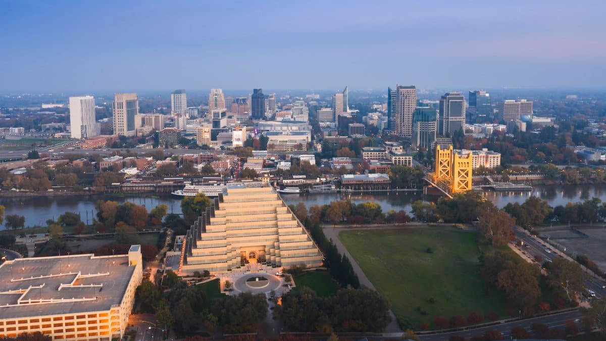 Stunning aerial view of Sacramento, California skyline with the iconic Tower Bridge at dusk.