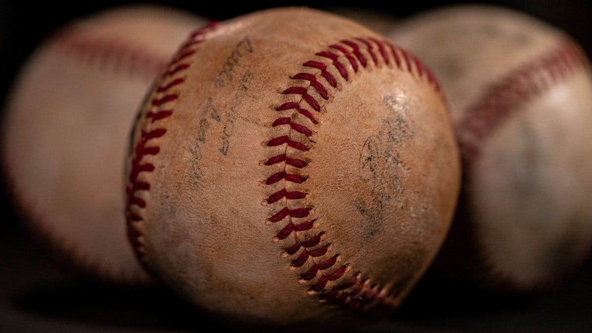 A close-up photo of weathered baseballs emphasizing texture and selective focus.