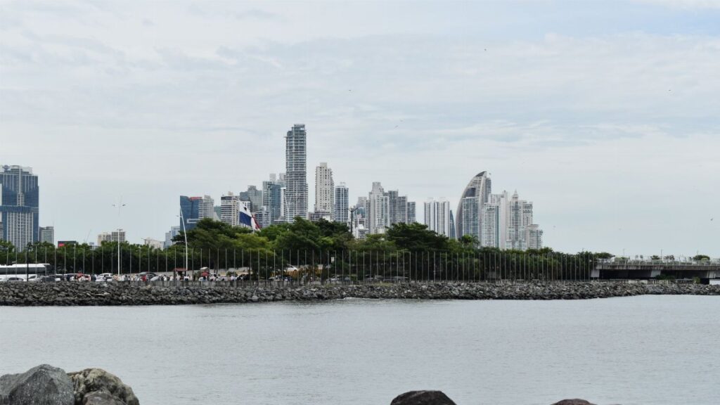 A scenic view of Panama City skyline captured from the waterfront, highlighting modern skyscrapers.