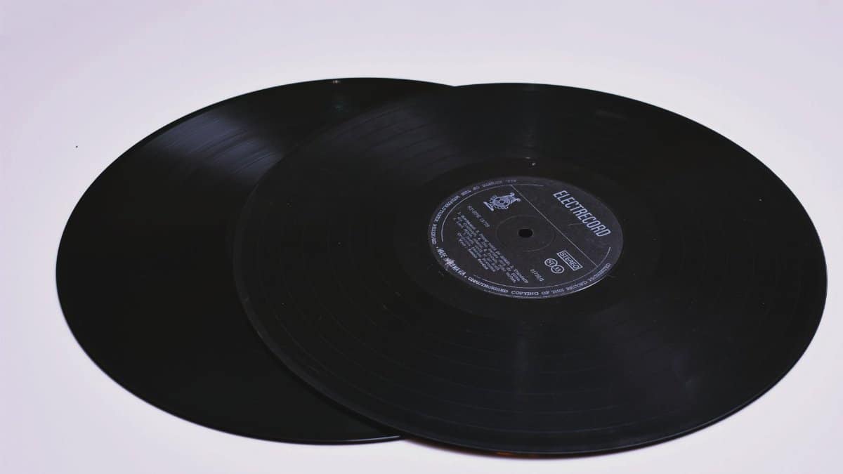 Close-up of two classic vinyl records on a flat surface, showcasing grooves.