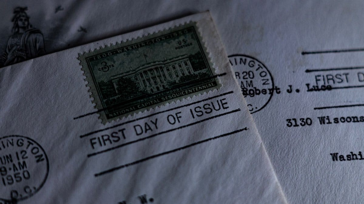 A close-up of a vintage first day of issue postage stamp on an envelope, evoking nostalgia.