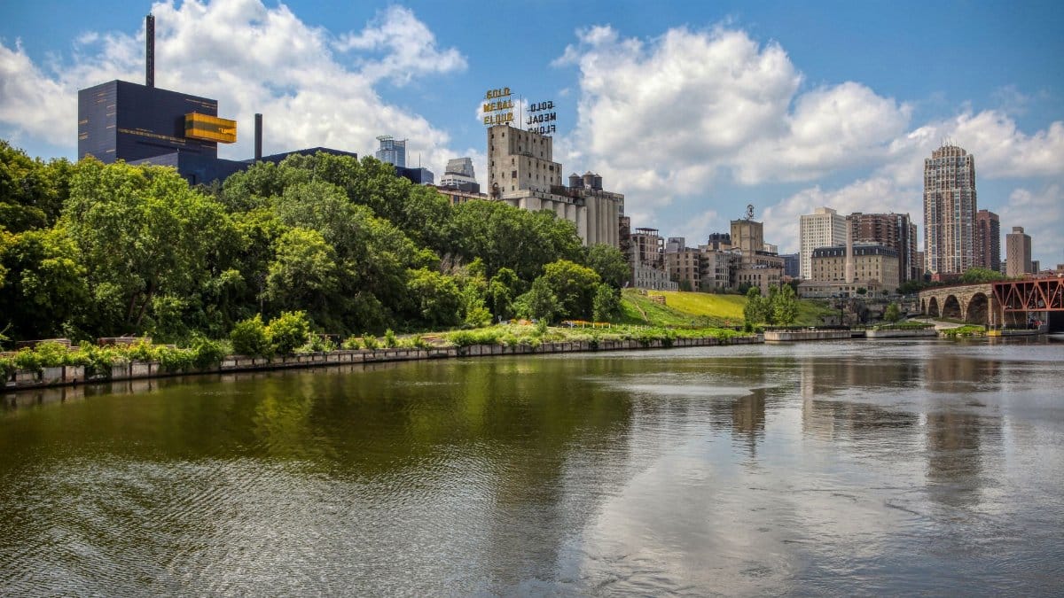 Discover the vibrant skyline of Minneapolis and the serene Mississippi River.