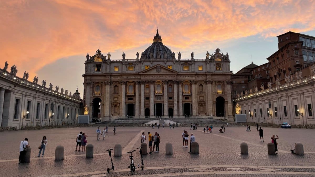 Stunning view of St. Peter's Basilica and Vatican City at sunset with vibrant skies.