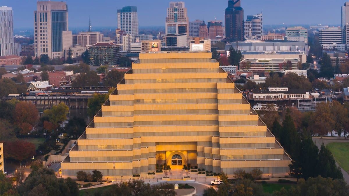 The vibrant Pyramid Building in Sacramento framed by the city's skyline at twilight.