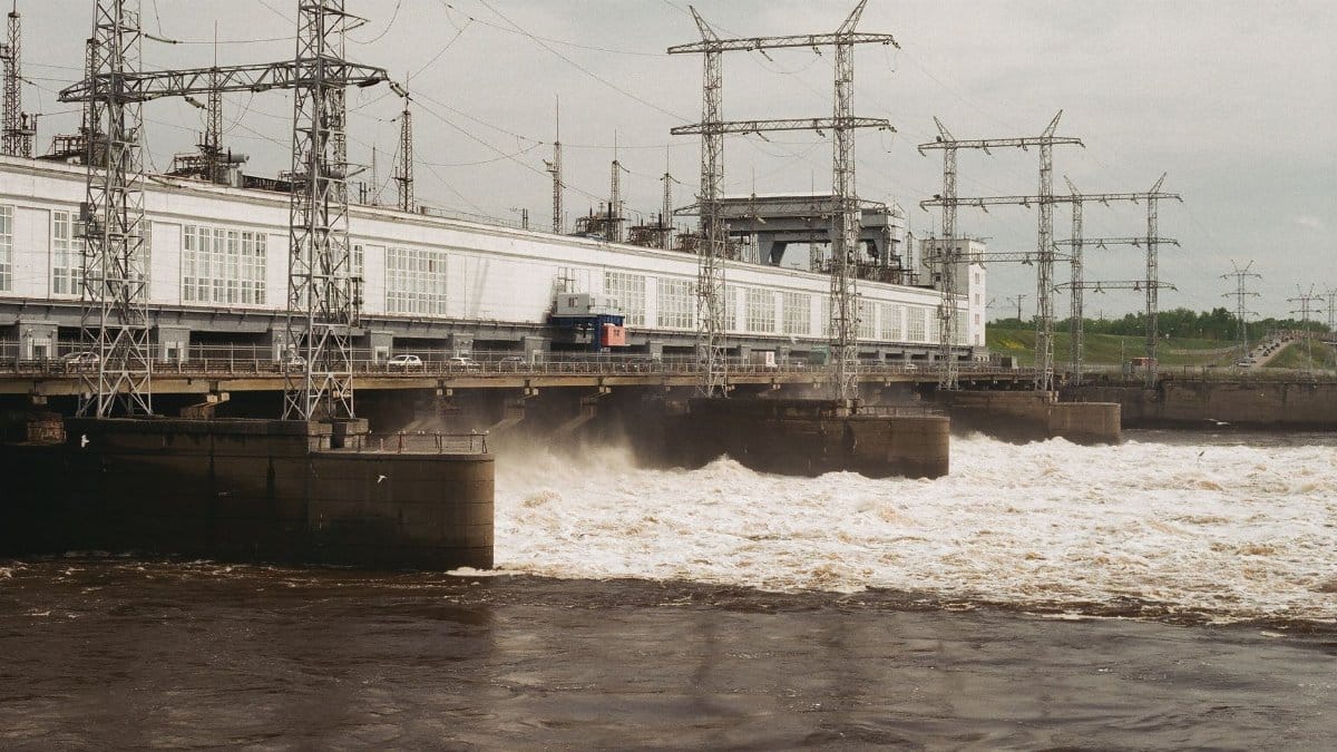 Hydroelectric dam with electric towers generating energy in Russia during the day.