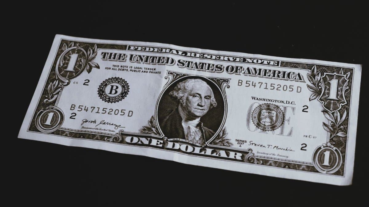 High-resolution image of a one dollar bill with intricate details on a dark background.
