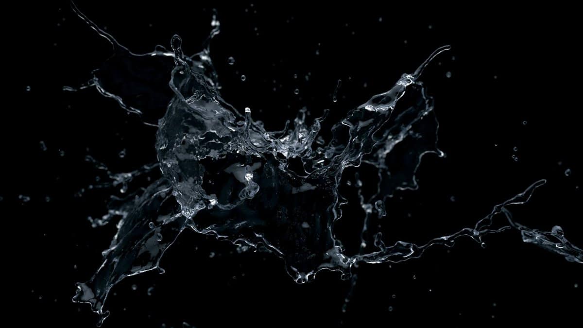 Dynamic close-up of water splash against a black backdrop, highlighting fluid motion and droplets.