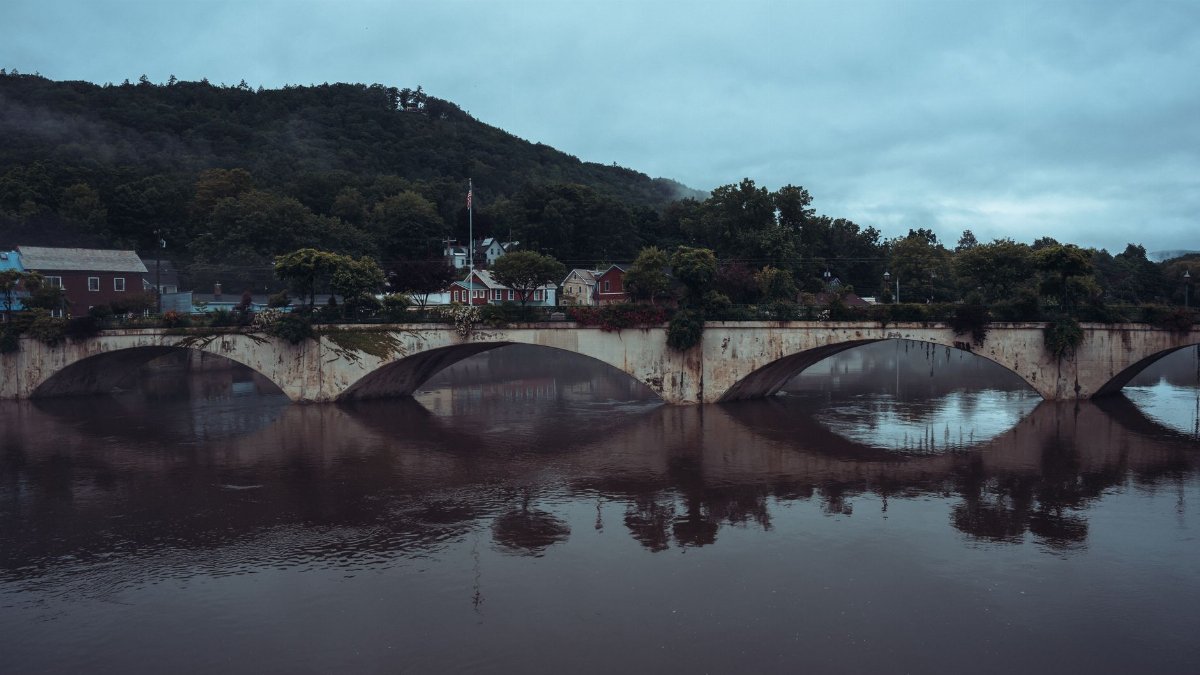 A serene view of the historic Bridge of Flowers in Shelburne Falls, Massachusetts at dusk.