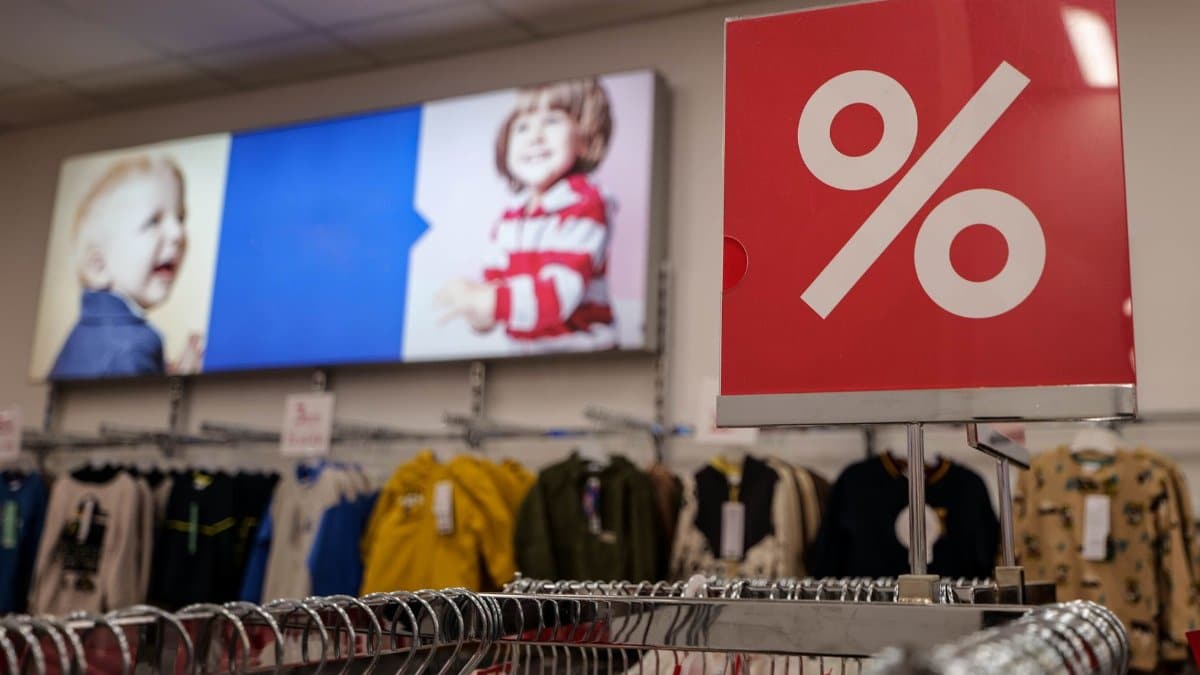 Children's clothing store with a prominent discount sign indicating a sale event.