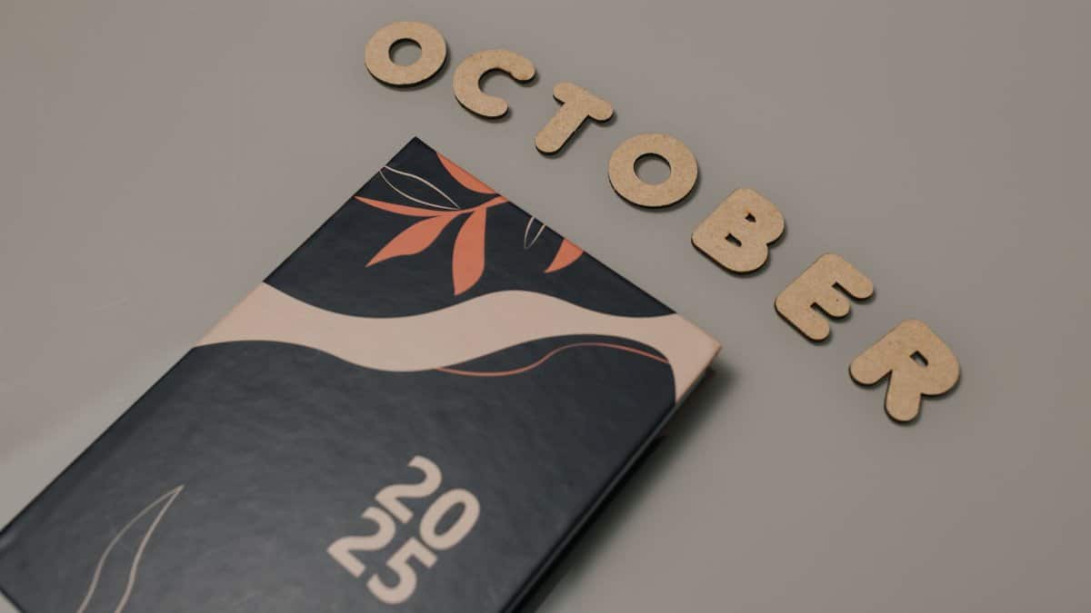 Stylish October 2025 planner with creative leaf art on a neutral background, perfect for organization.