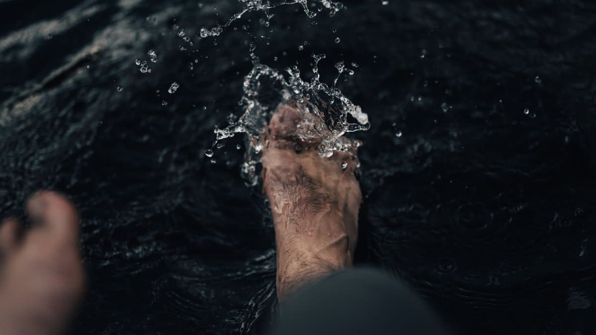 Close-up of a foot splashing and playing in water. Captures motion and refreshment.