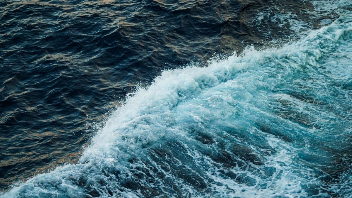 Capture of dynamic ocean waves with contrasting blue and white hues, showcasing natural oceanic beauty.