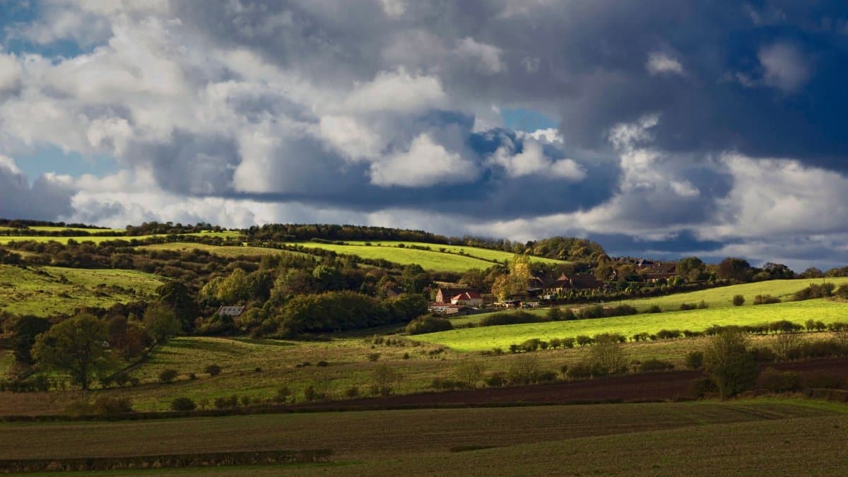 Beautiful rural landscape with rolling hills and fields under a dramatic sky in County Durham, UK.