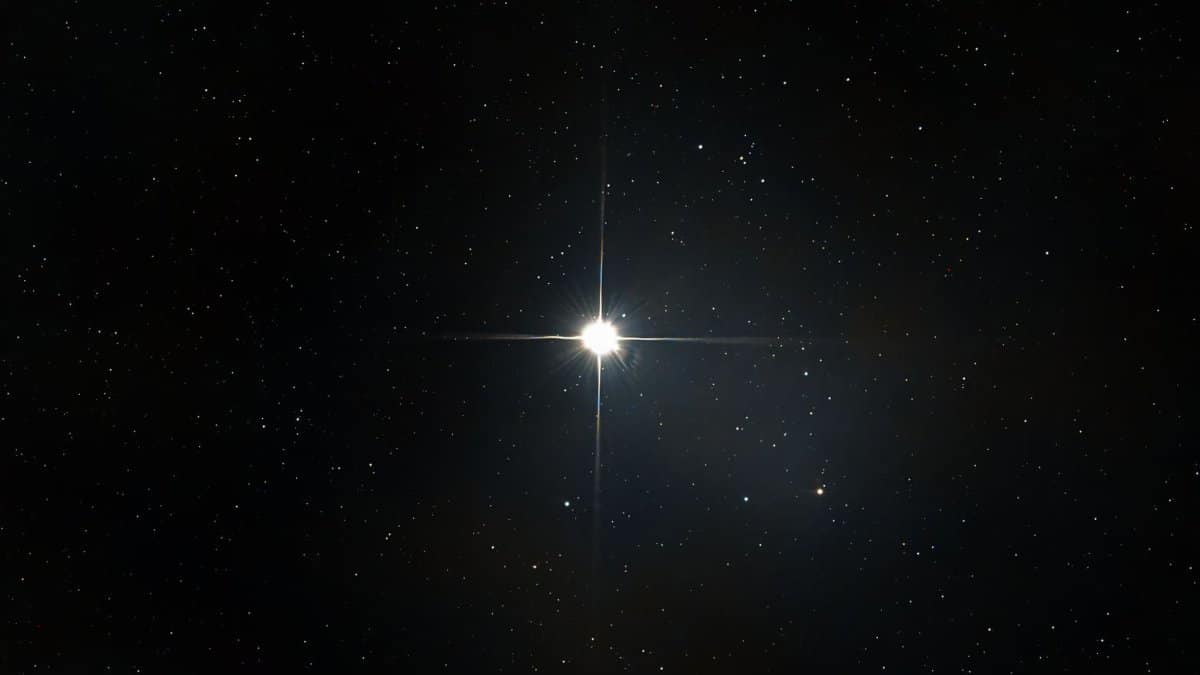 A bright star shines among countless stars in the vast, dark night sky.