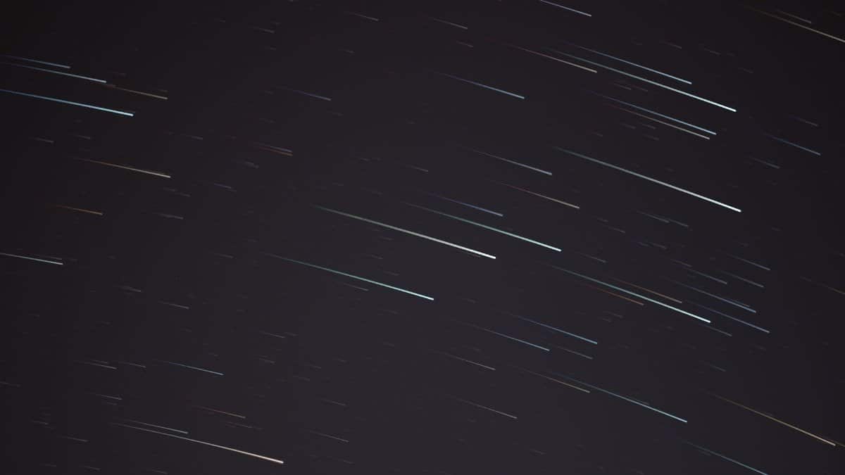 A mesmerizing long exposure photograph capturing streaking stars in the night sky.