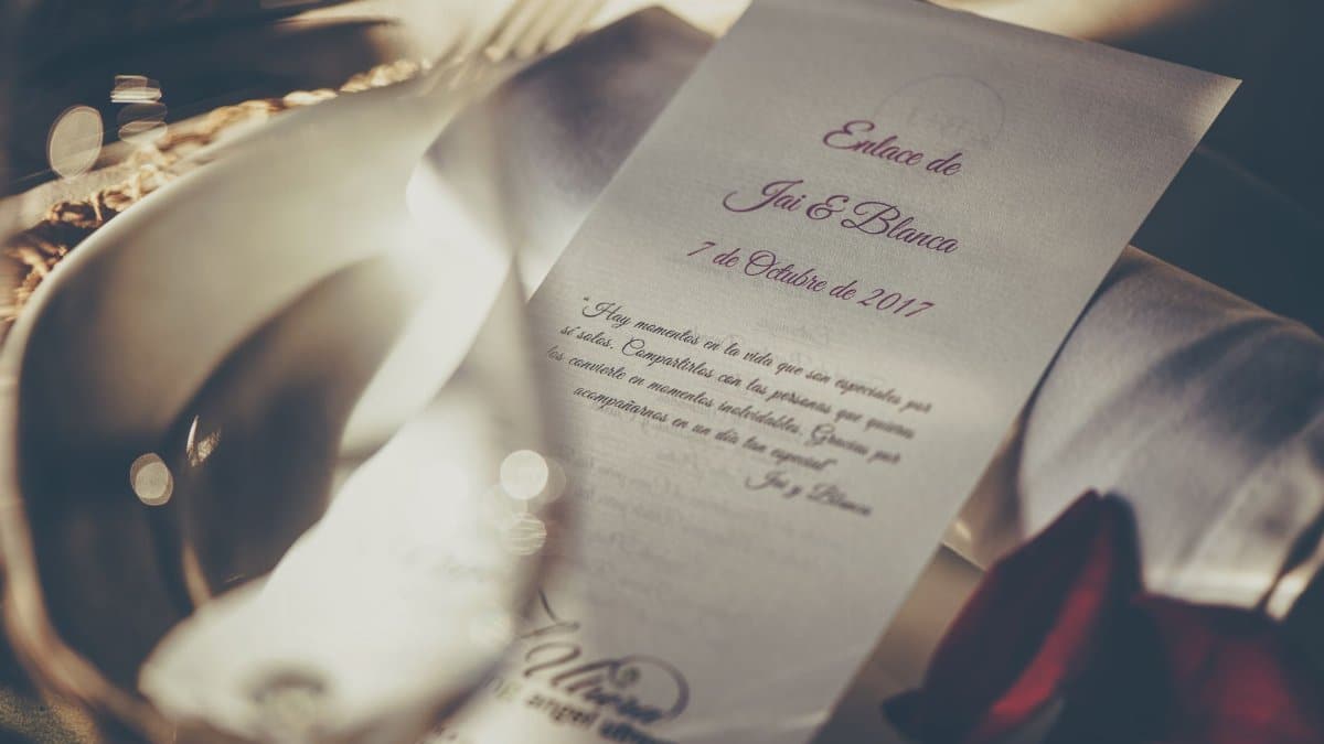 A romantic wedding invitation featuring elegant calligraphy, captured in soft focus for a dreamy feel.
