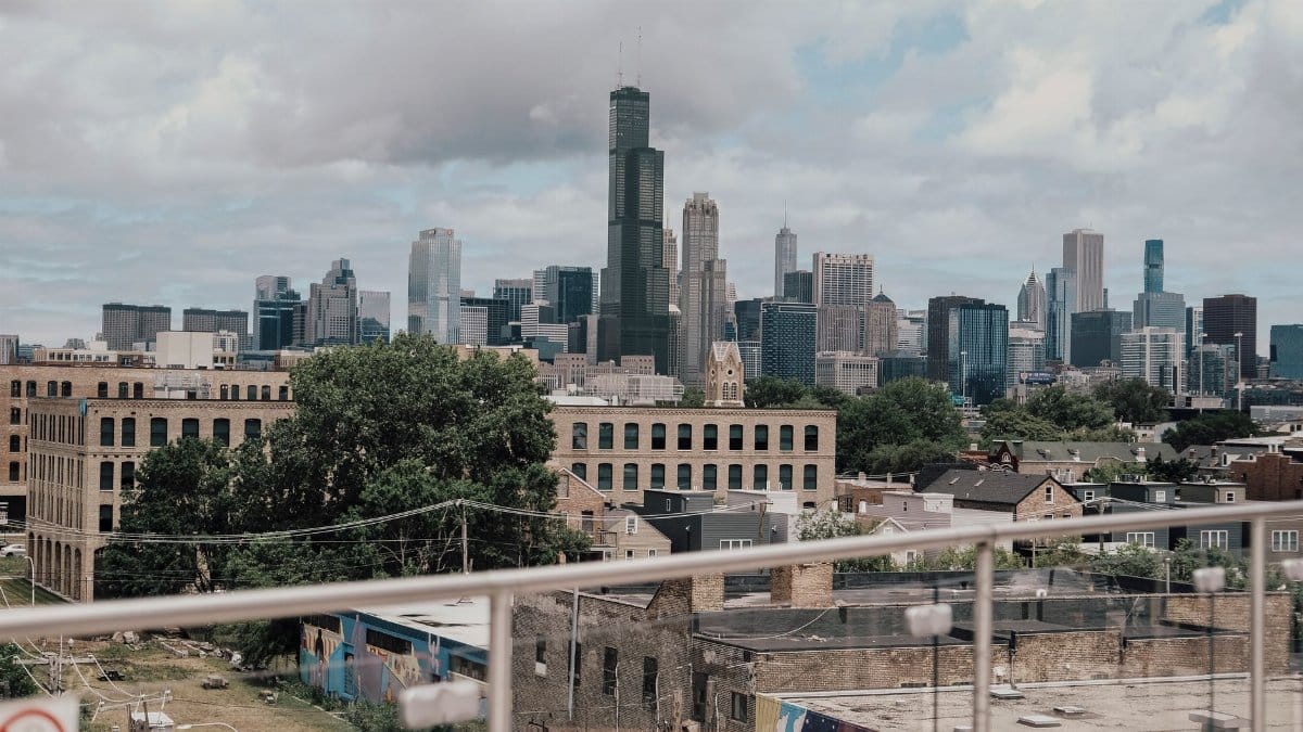 A clear view of the Chicago skyline from a rooftop with cloudy skies.