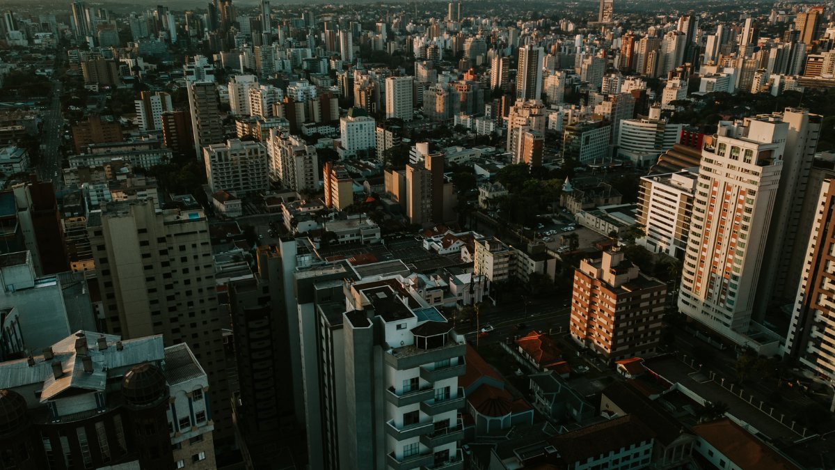 Stunning aerial view of Curitiba skyline at sunset featuring modern skyscrapers.