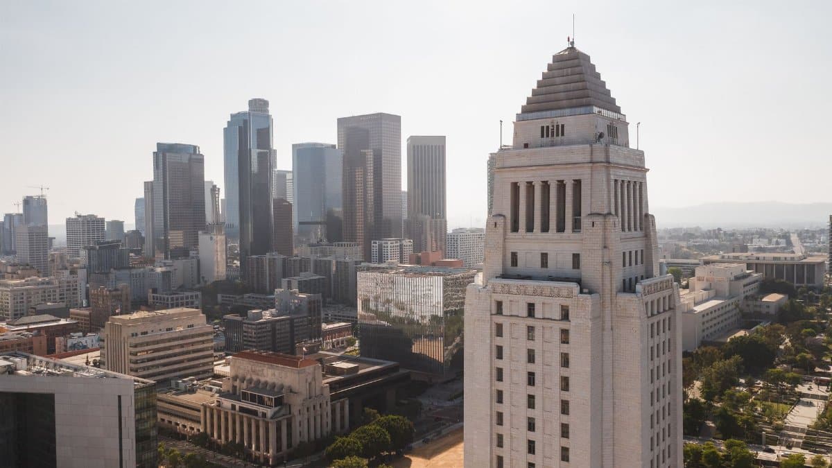 Aerial view of Los Angeles City Hall with the city skyline in the background.