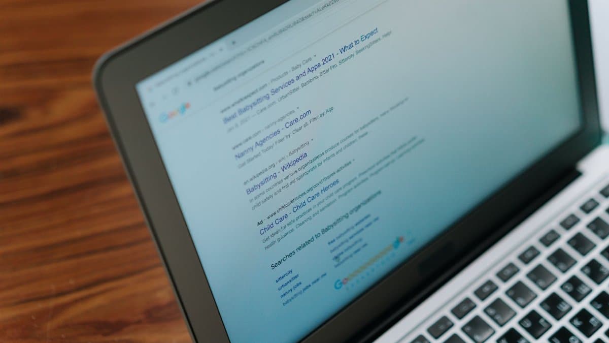 A close-up view of a laptop displaying a search engine page.
