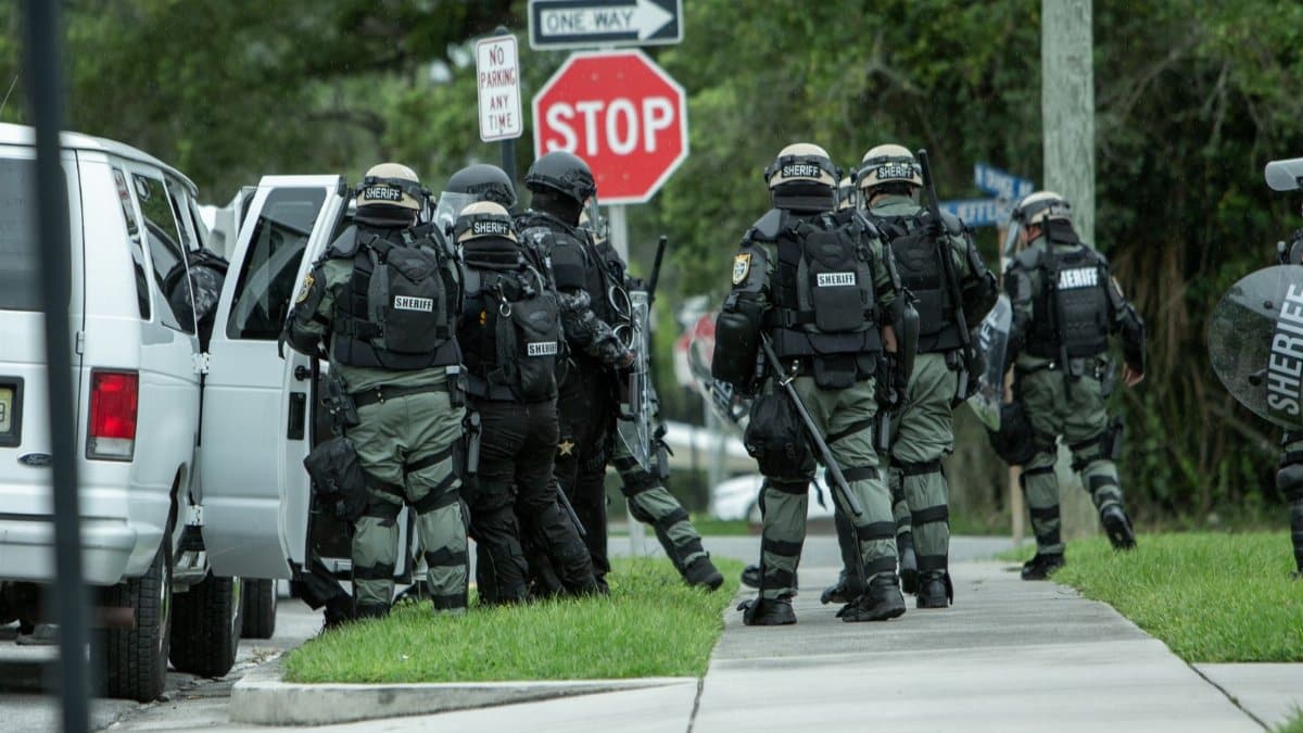 Police tactical unit in action during operation on a street in Brooksville, FL.