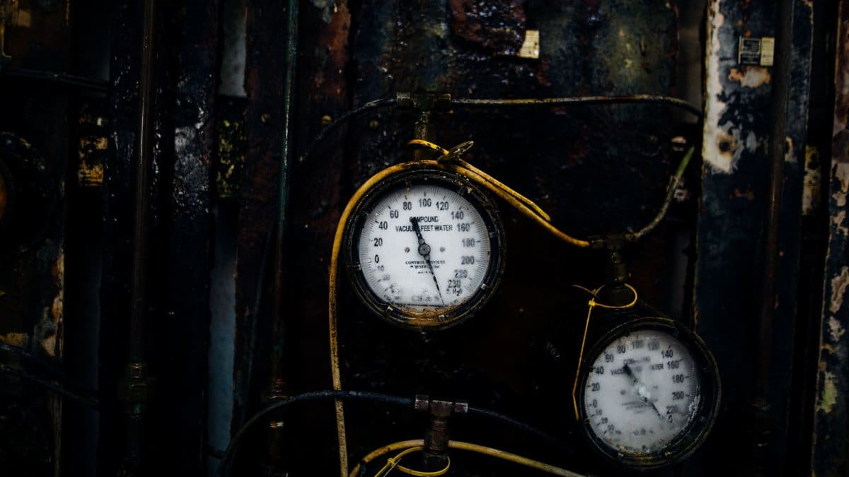 Close-up of old rusty pressure gauges in an industrial environment, showcasing decay and vintage charm.