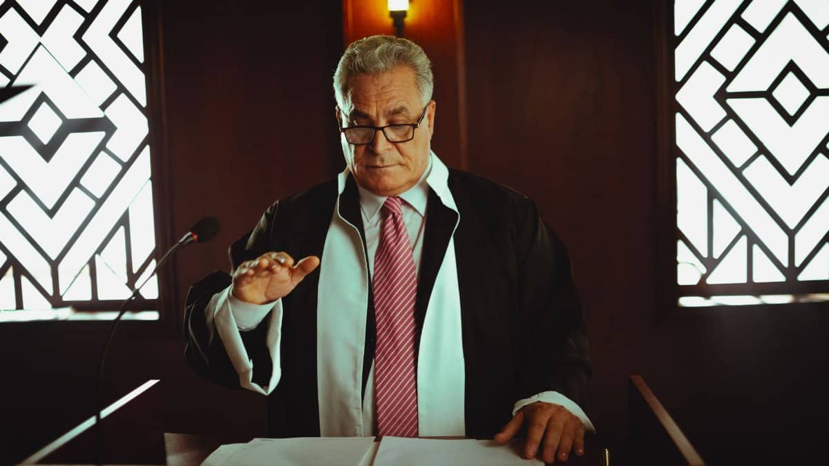Mature male judge in a courtroom taking an oath, Baghdad, Iraq.