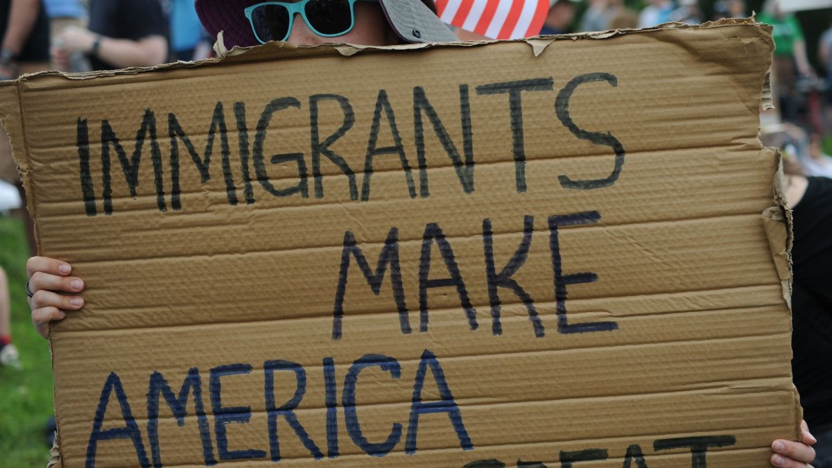 Close-up of sign reading 'Immigrants Make America Great' at a Baltimore rally.