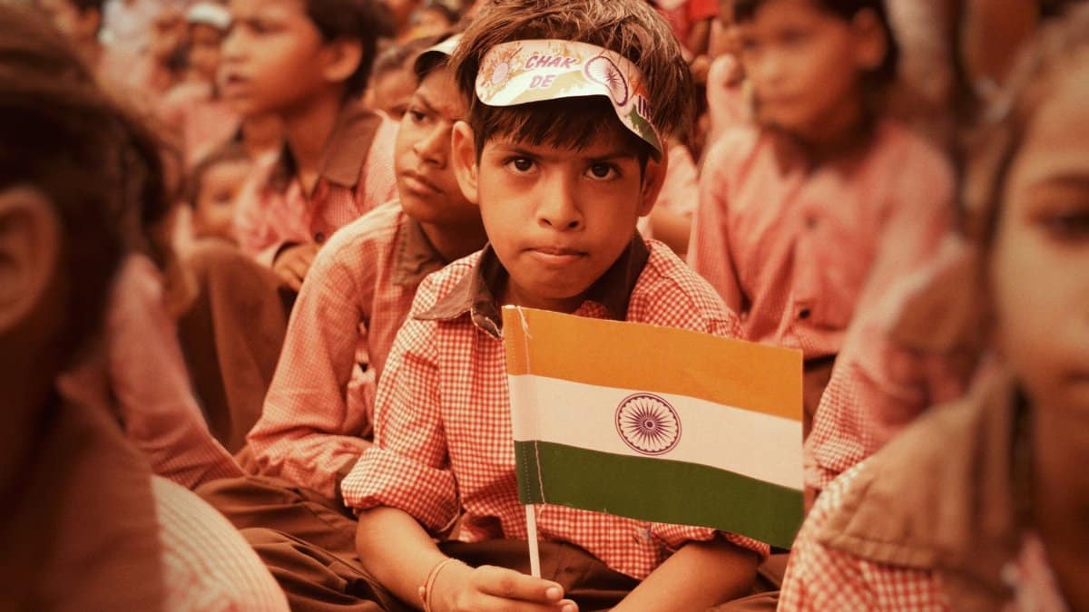 Children in Mathura, India celebrating Independence Day with Indian flags.