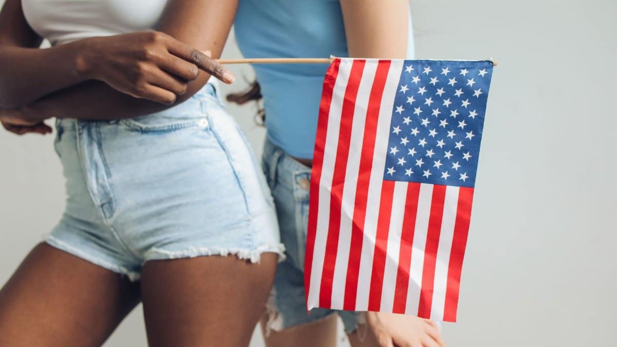 Two women holding an American flag, symbolizing unity and patriotism.