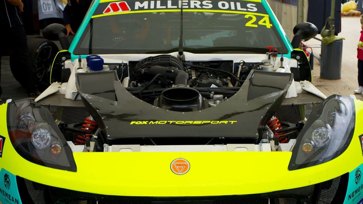 Detailed view of a race car engine and front end at Silverstone motorsport event.