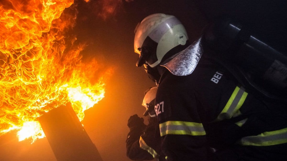 Brave firefighters in action combating a massive, dangerous blaze indoors.