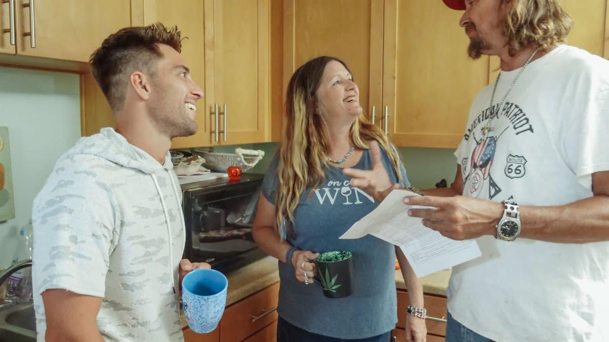 A joyful family converses in the kitchen, sharing quality time.